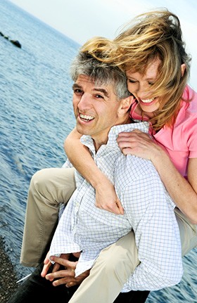 Mature romantic couple with woman on man's back