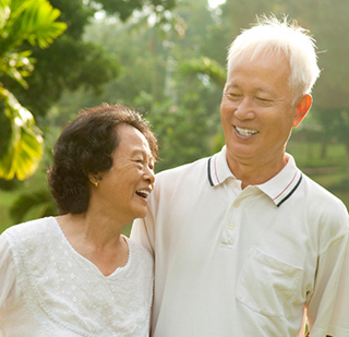 Older Asian couple smiling together