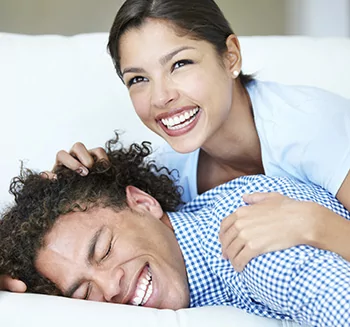 Young couple lying on a bed and smiling