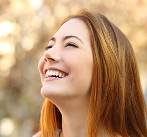 Girl with reddish orange hair smiling