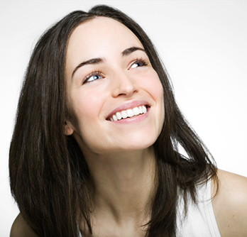 A woman smiling with straightened teeth from Invisalign