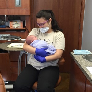 Staff member at Hamilton Family Dentistry holding an infant | Frenectomy services in Bryant, AR