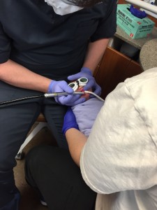 Dr. Hamilton during a frenectomy procedure